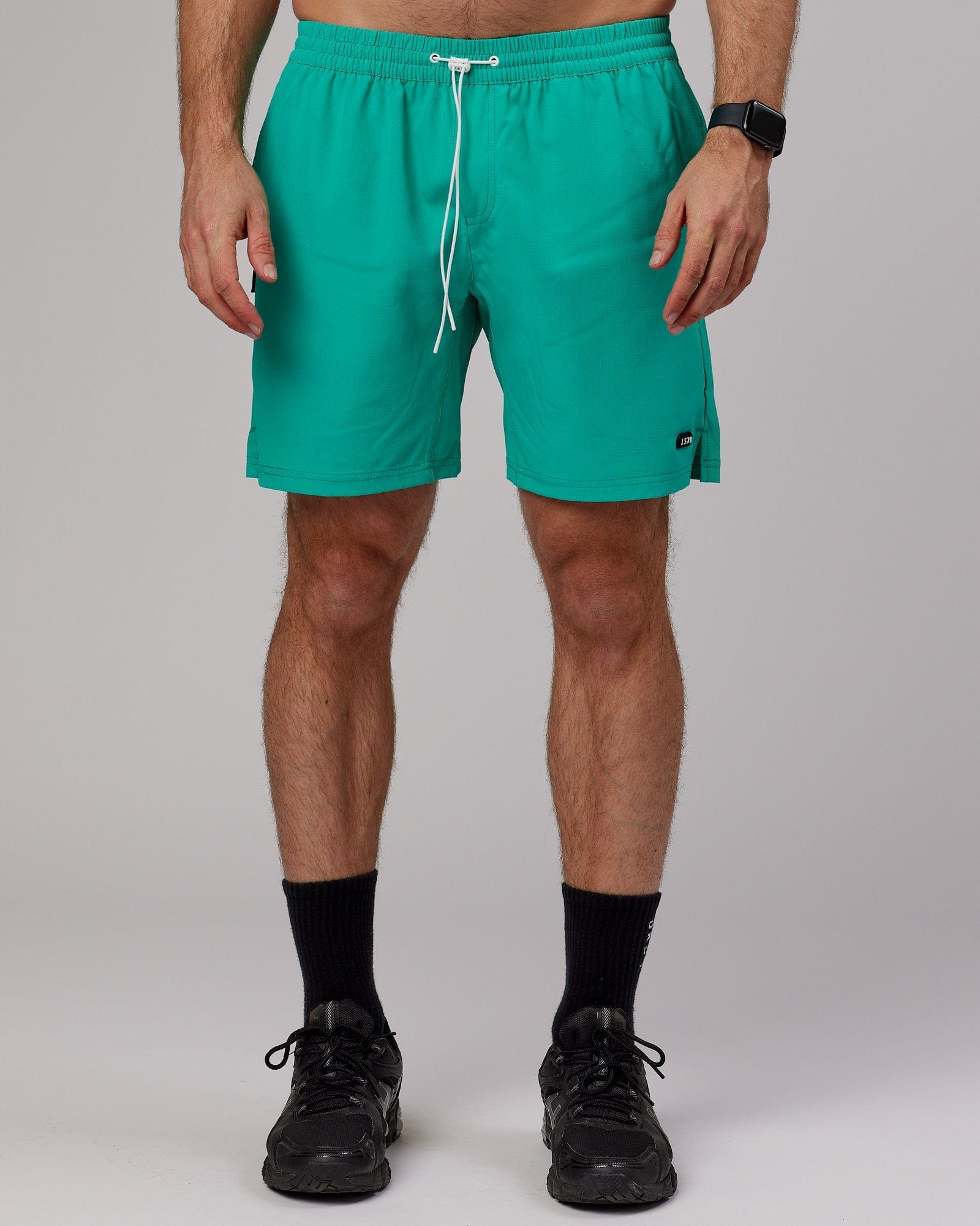 Model wearing Capsule 7" Performance Short - Hyper Teal