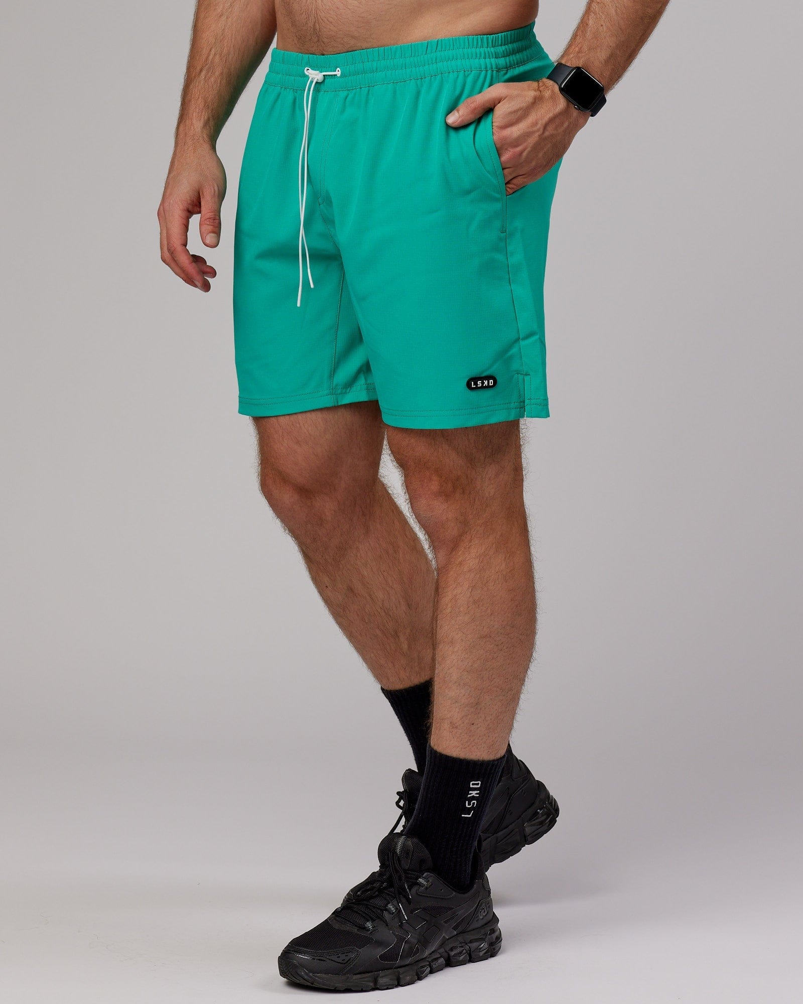 Model wearing Capsule 7" Performance Short - Hyper Teal