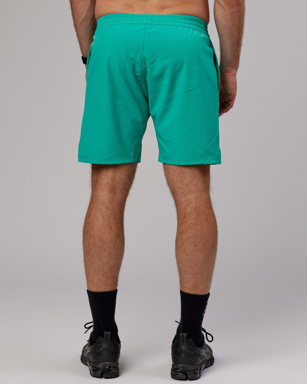 Model wearing Capsule 7" Performance Short - Hyper Teal