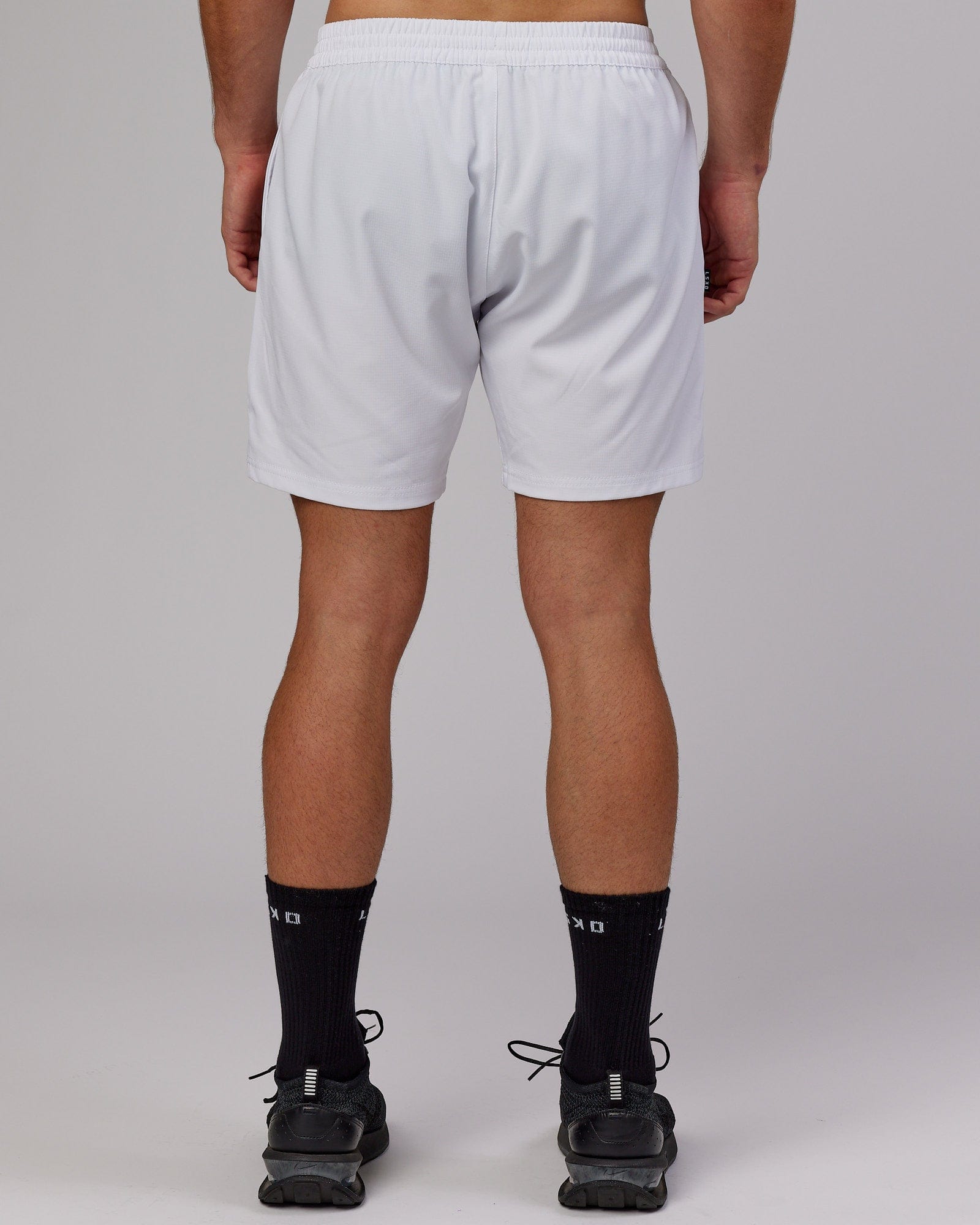 Model wearing Capsule 7" Performance Short - White