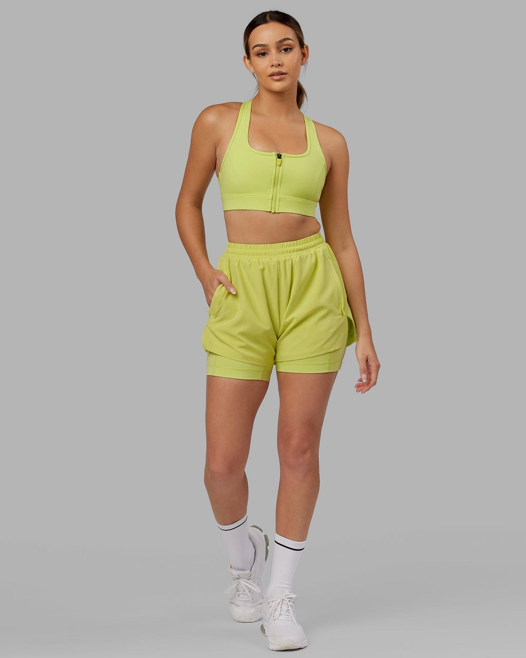 Model wearing Challenger Liner Run Short - Citrus Green