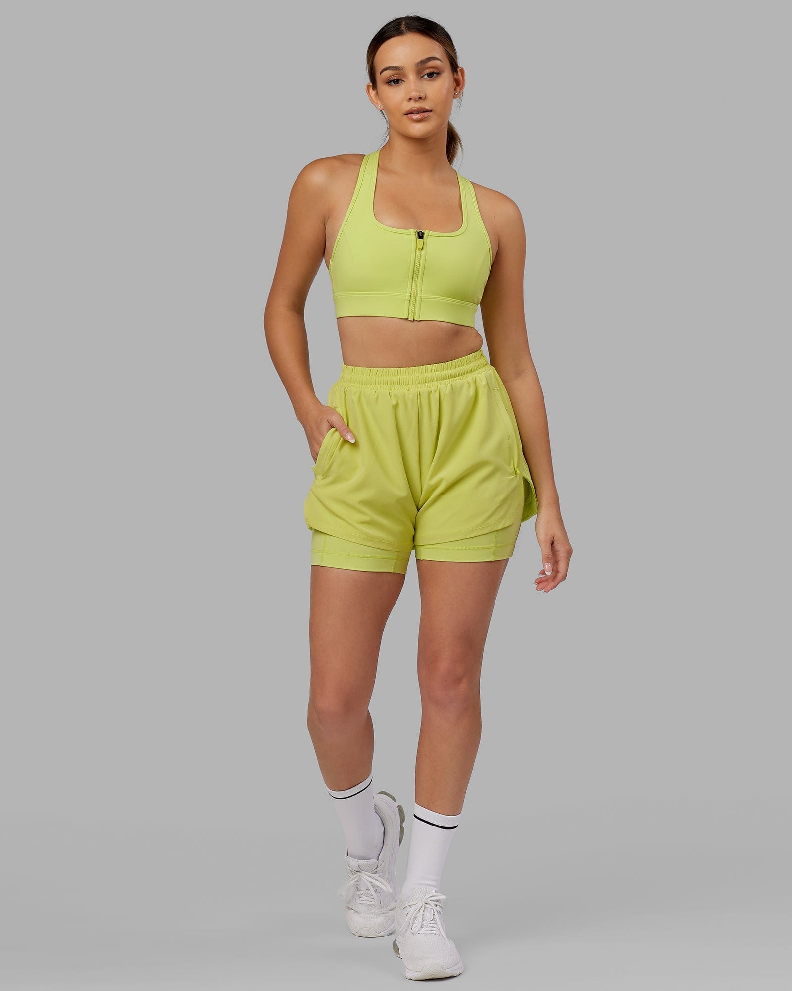 Model wearing Challenger Liner Run Short - Citrus Green