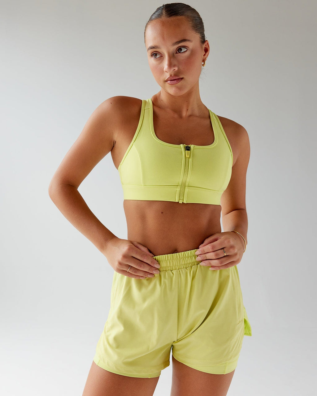 Model wearing Challenger Liner Run Short - Citrus Green