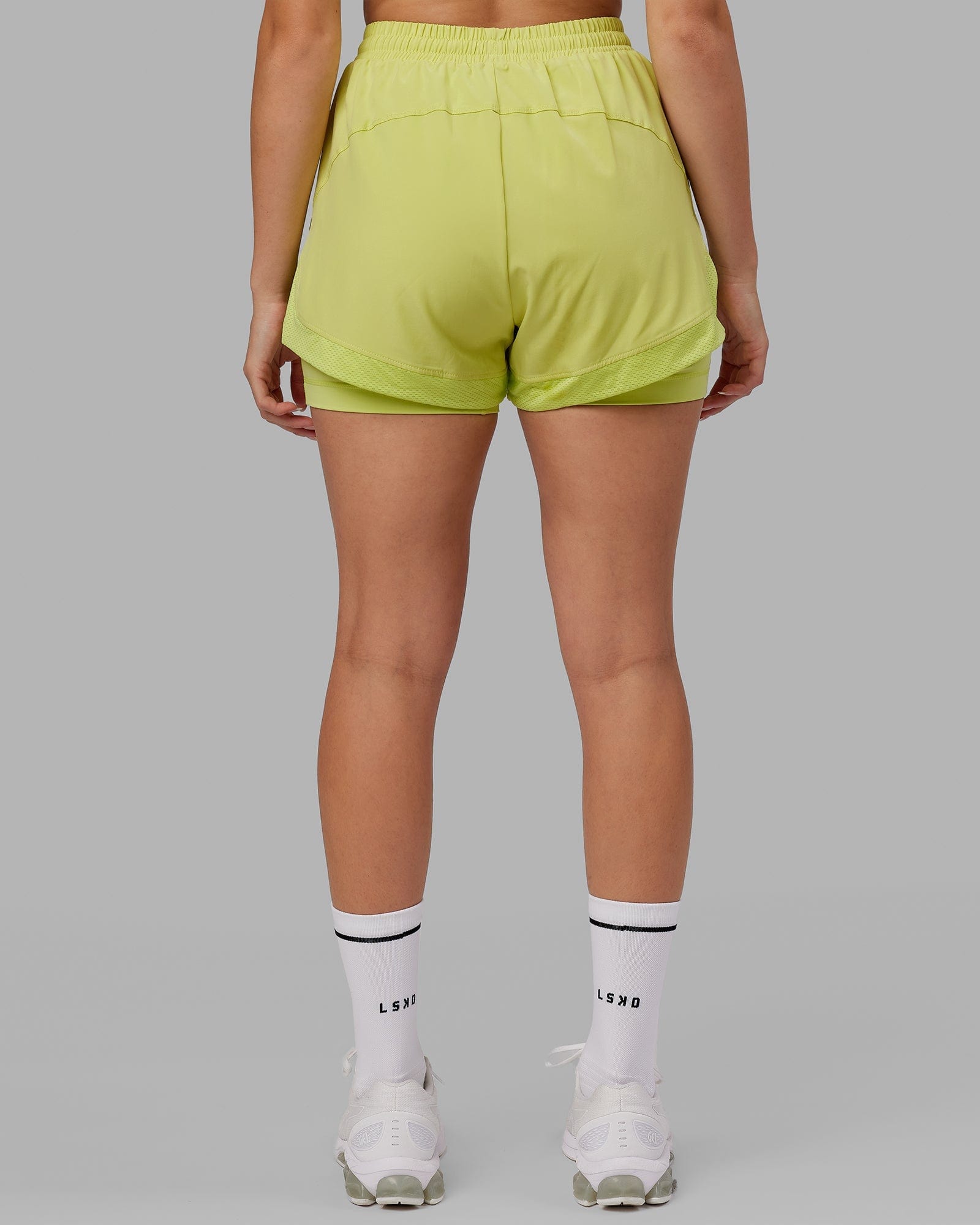 Model wearing Challenger Liner Run Short - Citrus Green