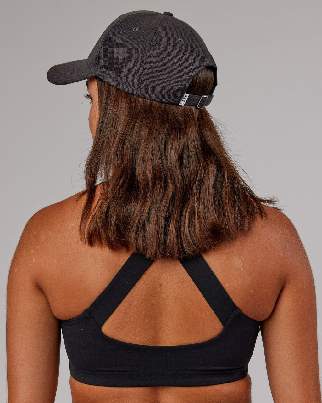 Model wearing Classic Strapback Cap - Asphalt