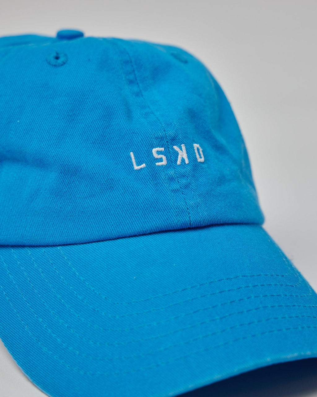 Model wearing Compact Cap - Washed Ibiza Blue