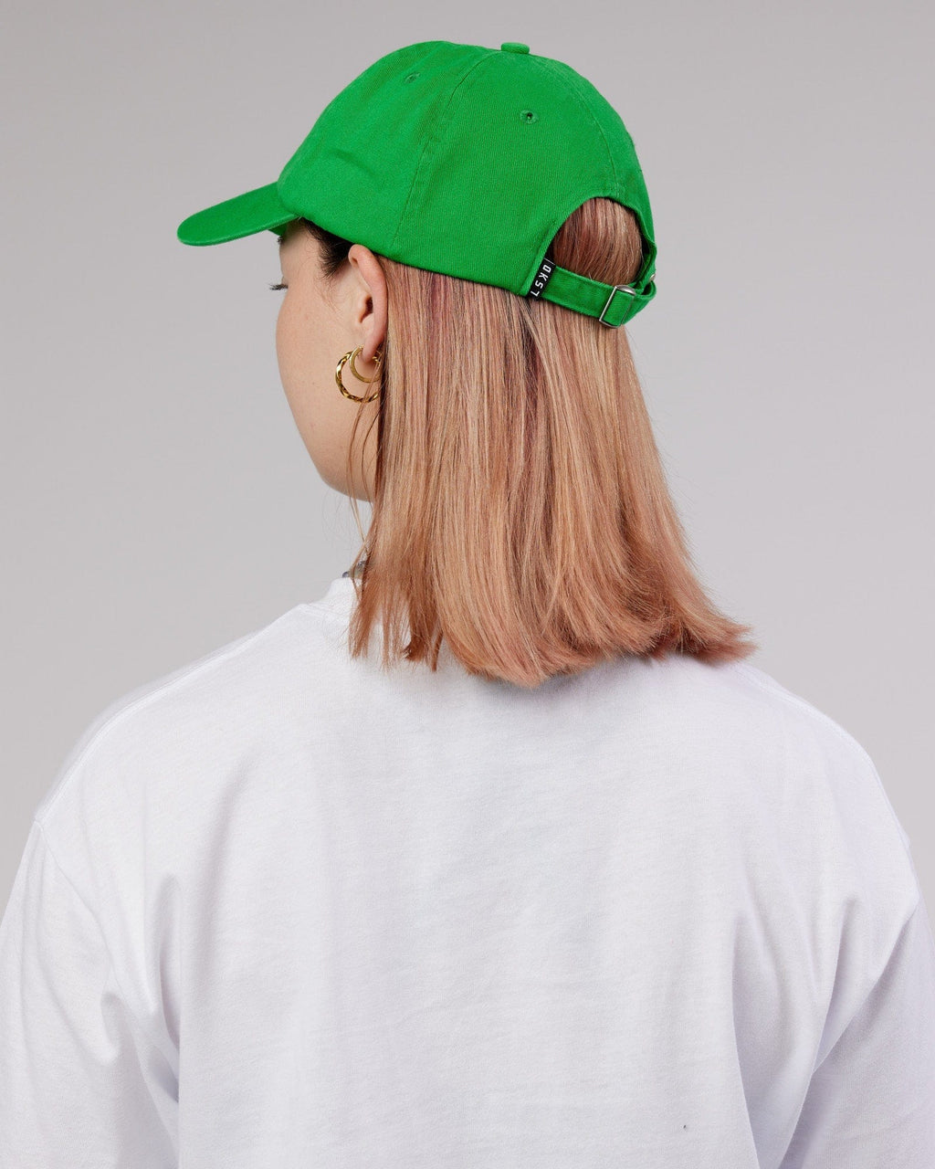 Model wearing Compact Cap - Washed Vivid Green