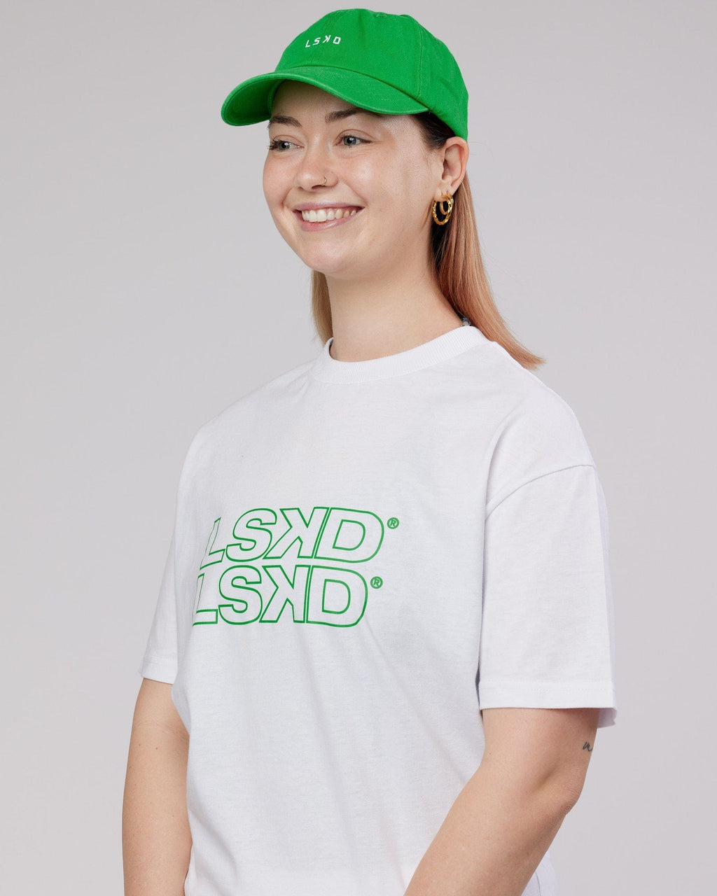 Model wearing Compact Cap - Washed Vivid Green