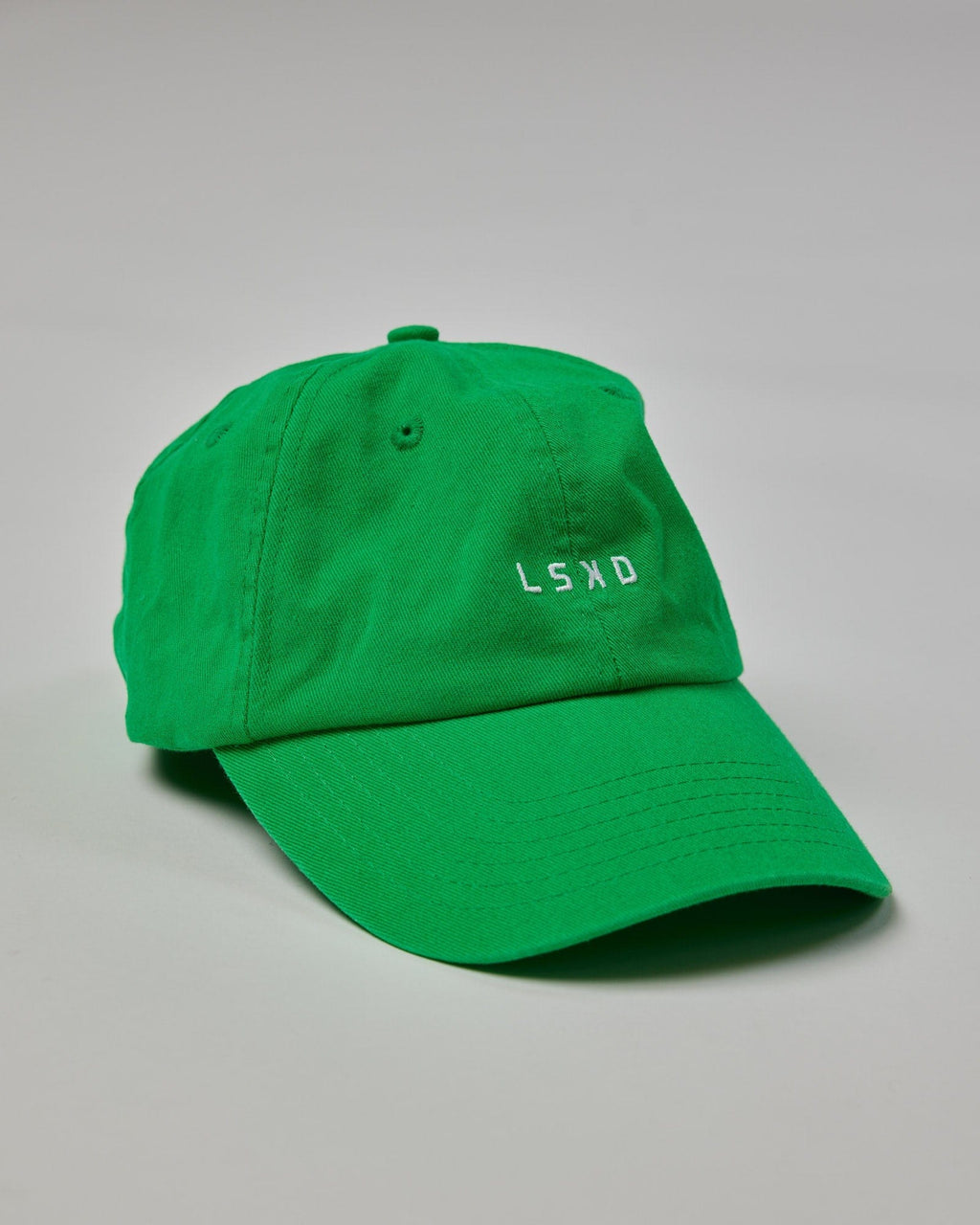 Model wearing Compact Cap - Washed Vivid Green