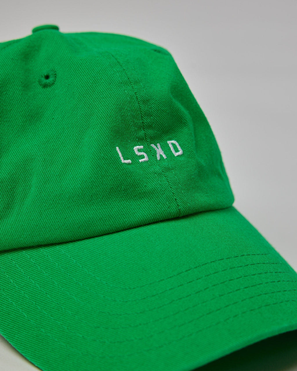 Model wearing Compact Cap - Washed Vivid Green