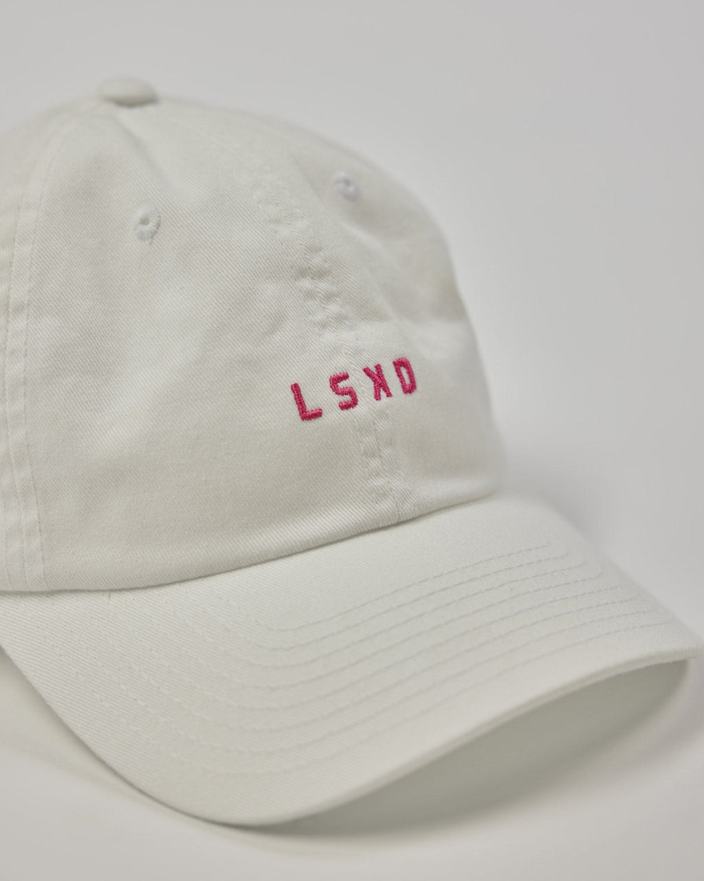 Model wearing Compact Cap - White-Flamingo