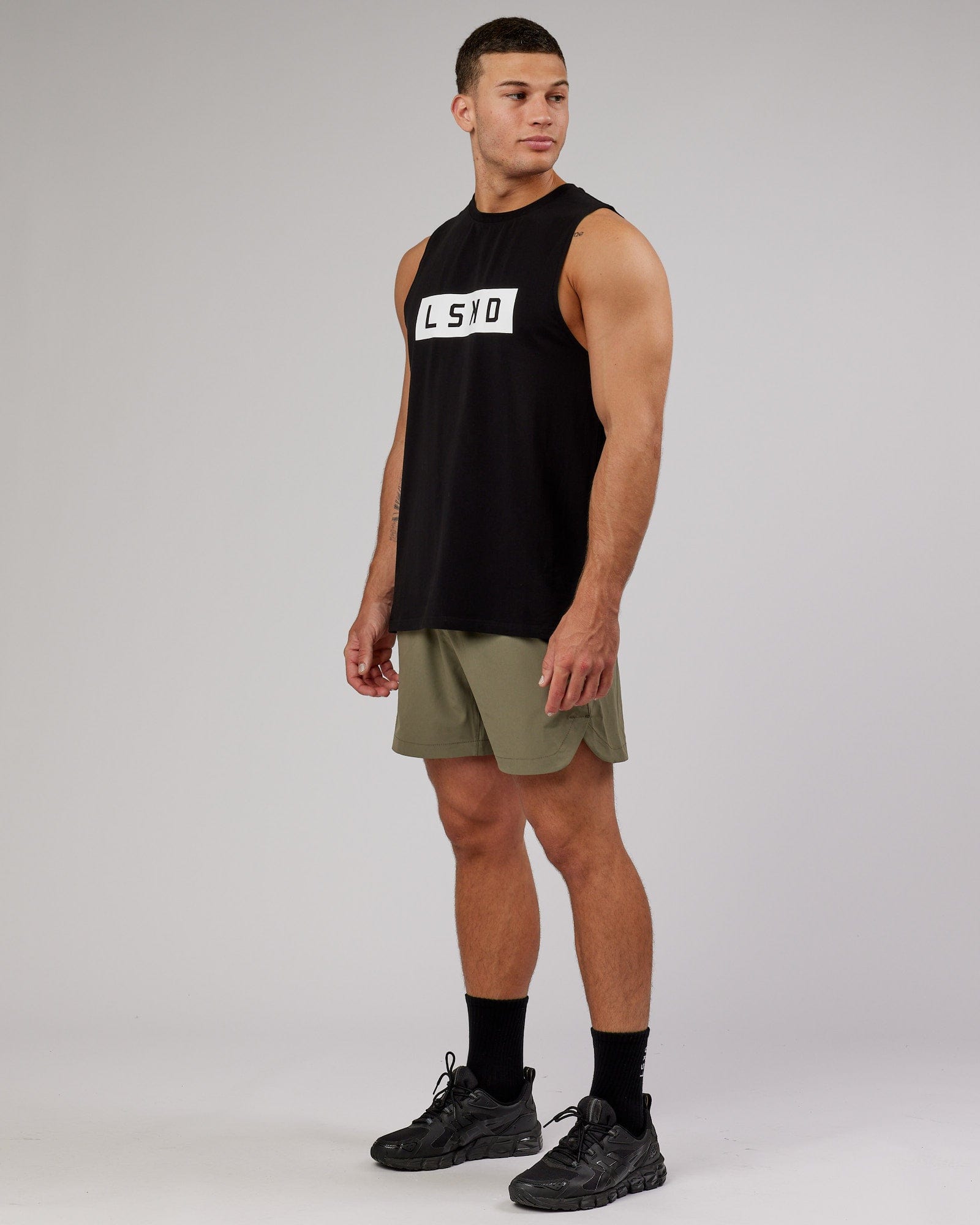 Model wearing Competition 5" Performance Short - Olive Fade
