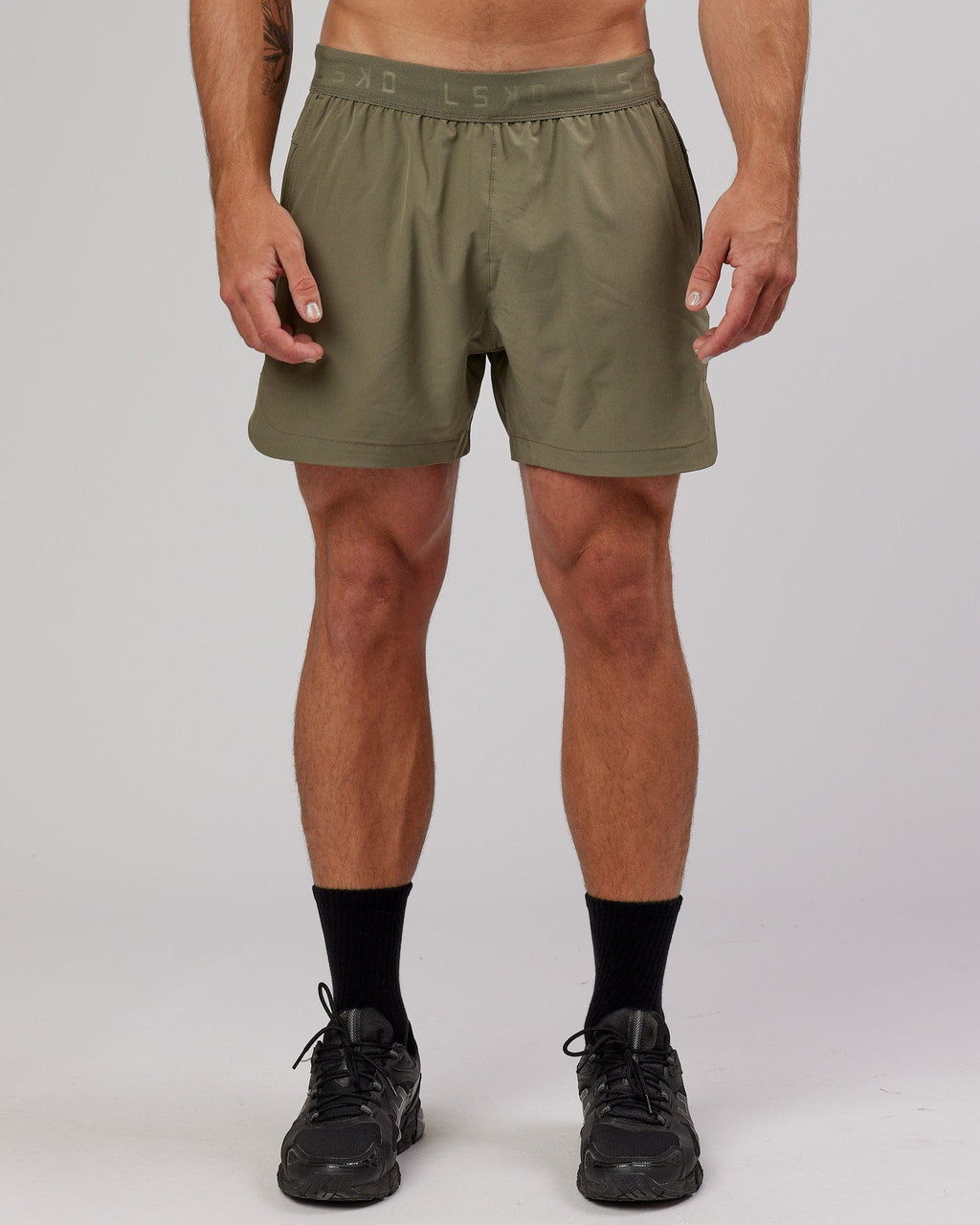 Model wearing Competition 5" Performance Short - Olive Fade