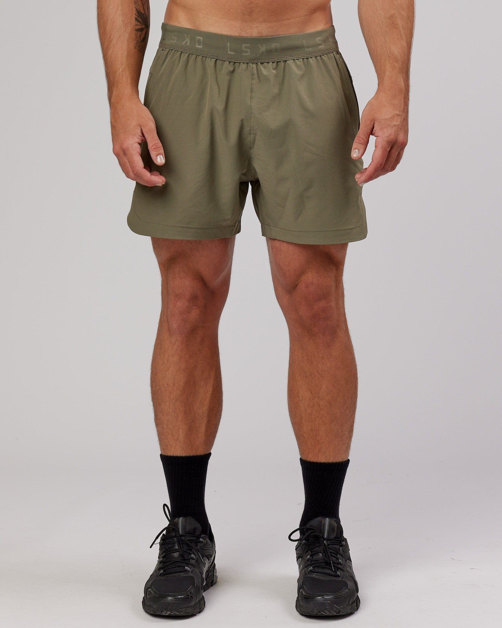 Model wearing Competition 5" Performance Short - Olive Fade