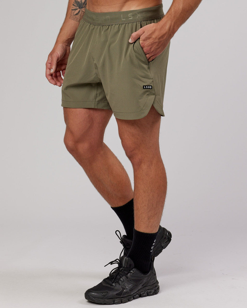 Model wearing Competition 5" Performance Short - Olive Fade