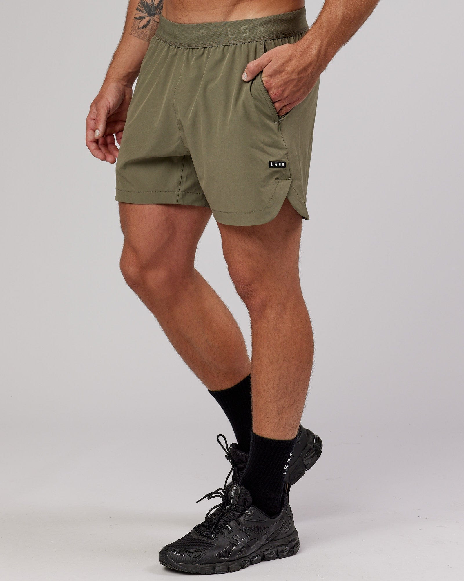 Model wearing Competition 5" Performance Short - Olive Fade