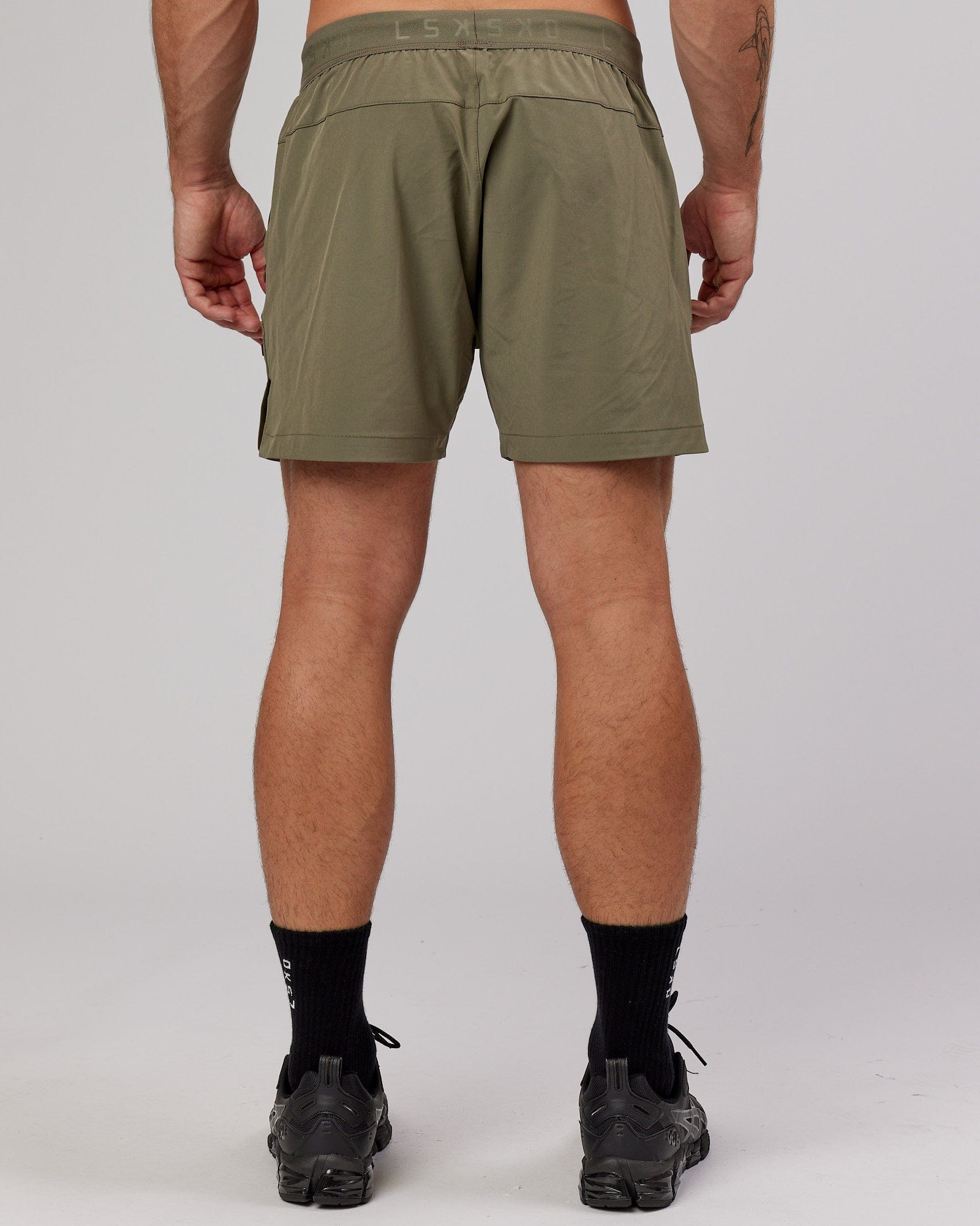 Model wearing Competition 5" Performance Short - Olive Fade