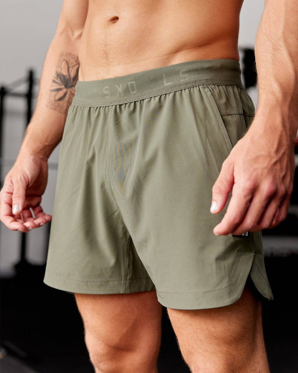 Model wearing Competition 5" Performance Short - Olive Fade