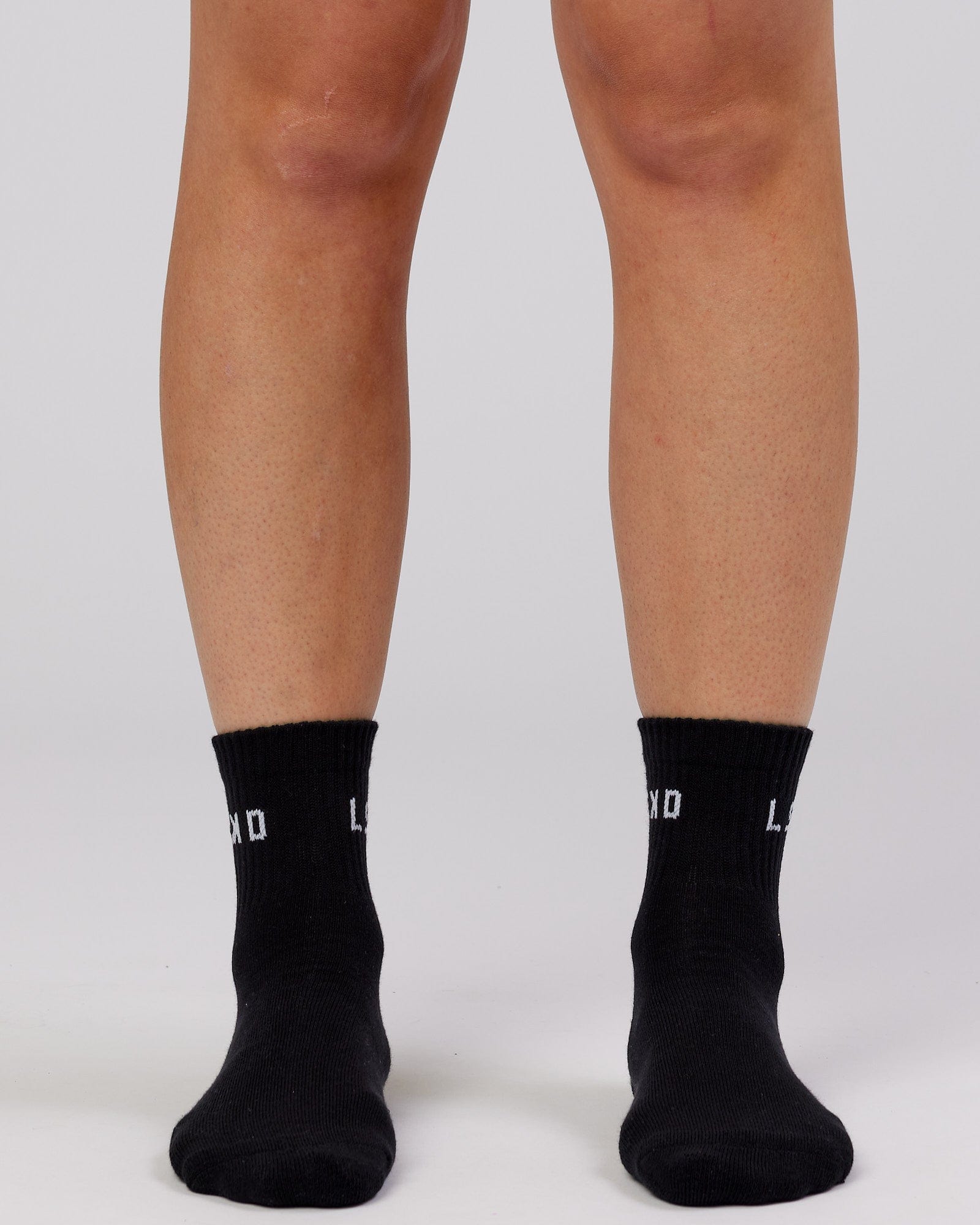 Model wearing Daily Quarter Crew Sock - Black