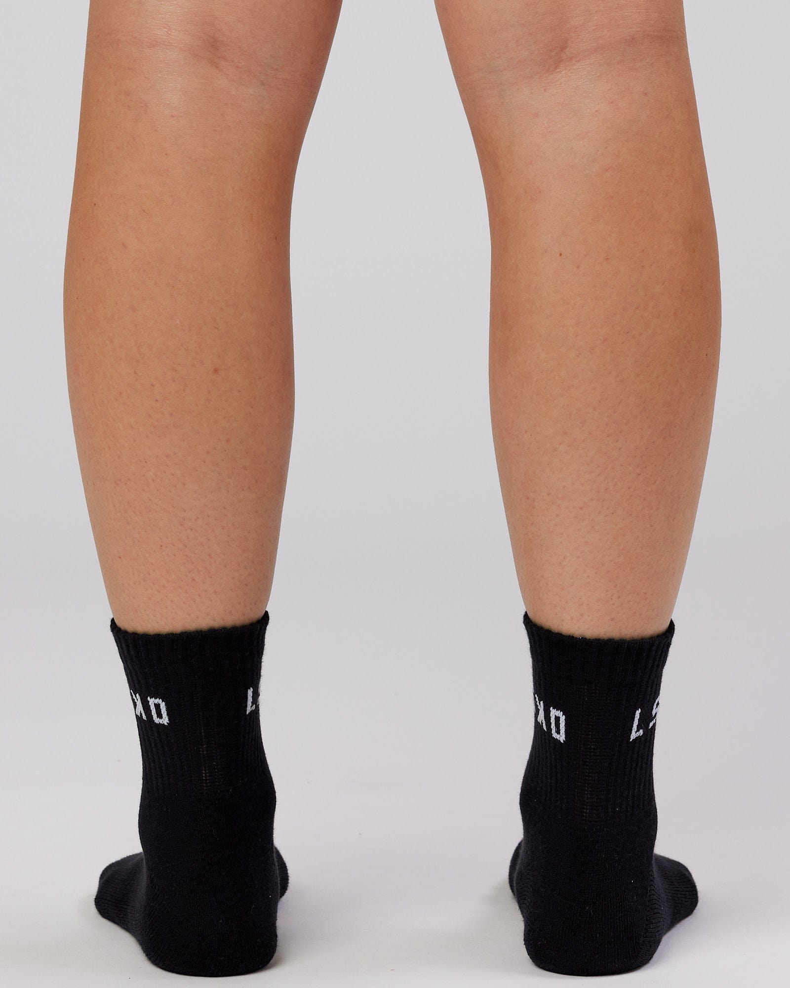 Model wearing Daily Quarter Crew Sock - Black