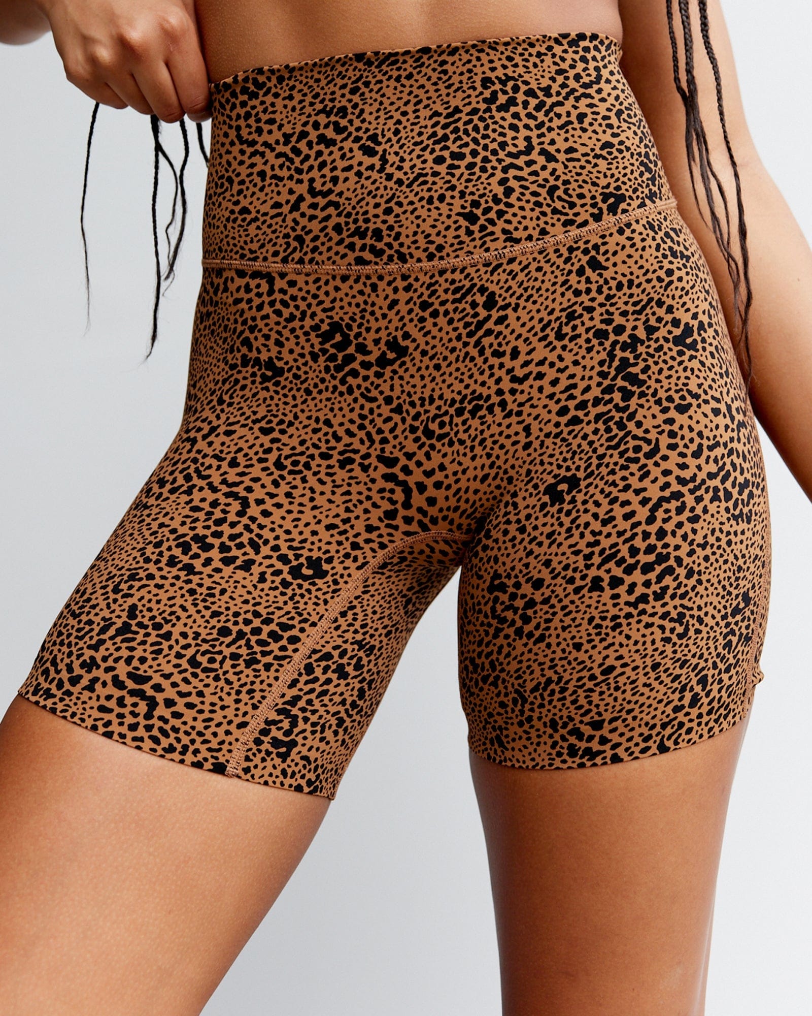 Model wearing Elixir Mid Short Tight - Agile Camel Print