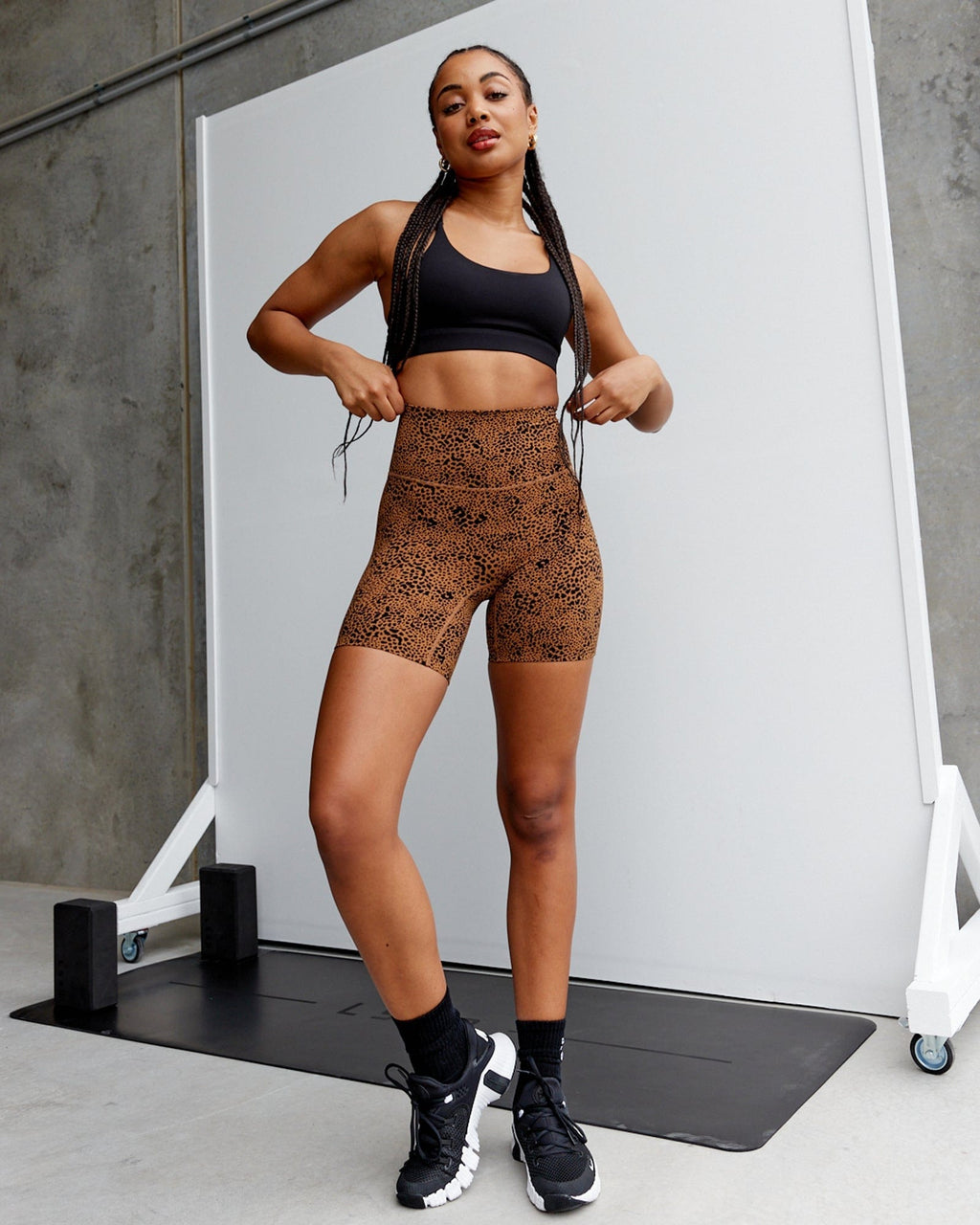 Model wearing Elixir Mid Short Tight - Agile Camel Print