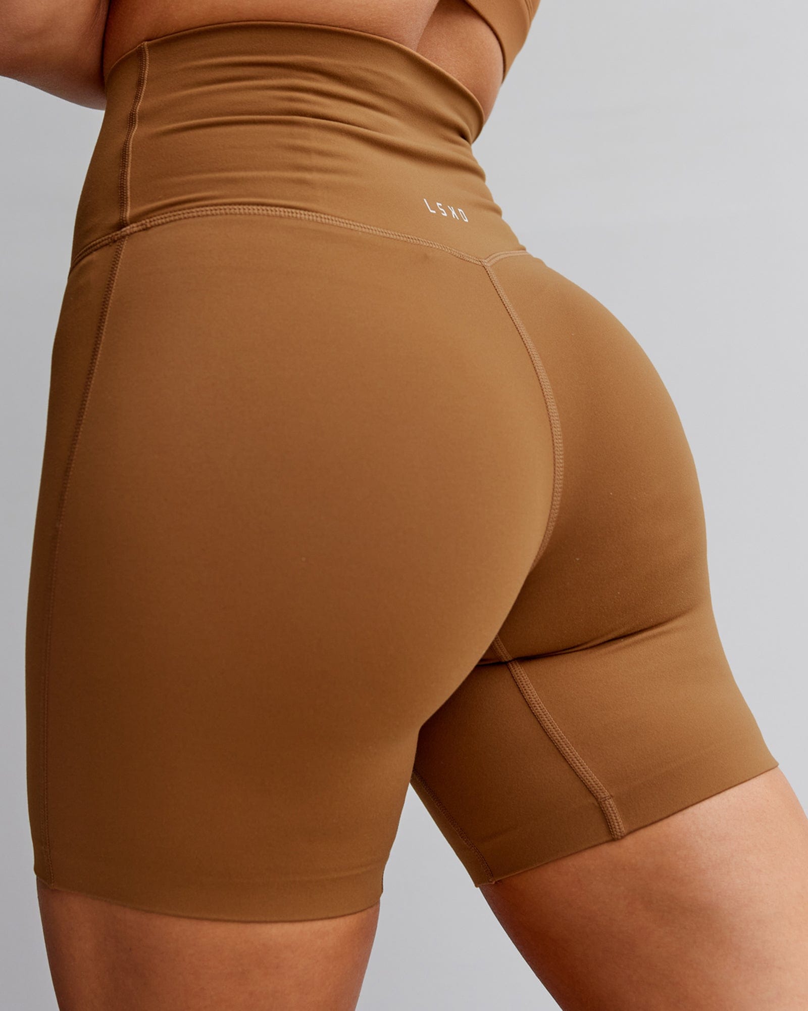 Model wearing Elixir Mid Short Tight - Camel