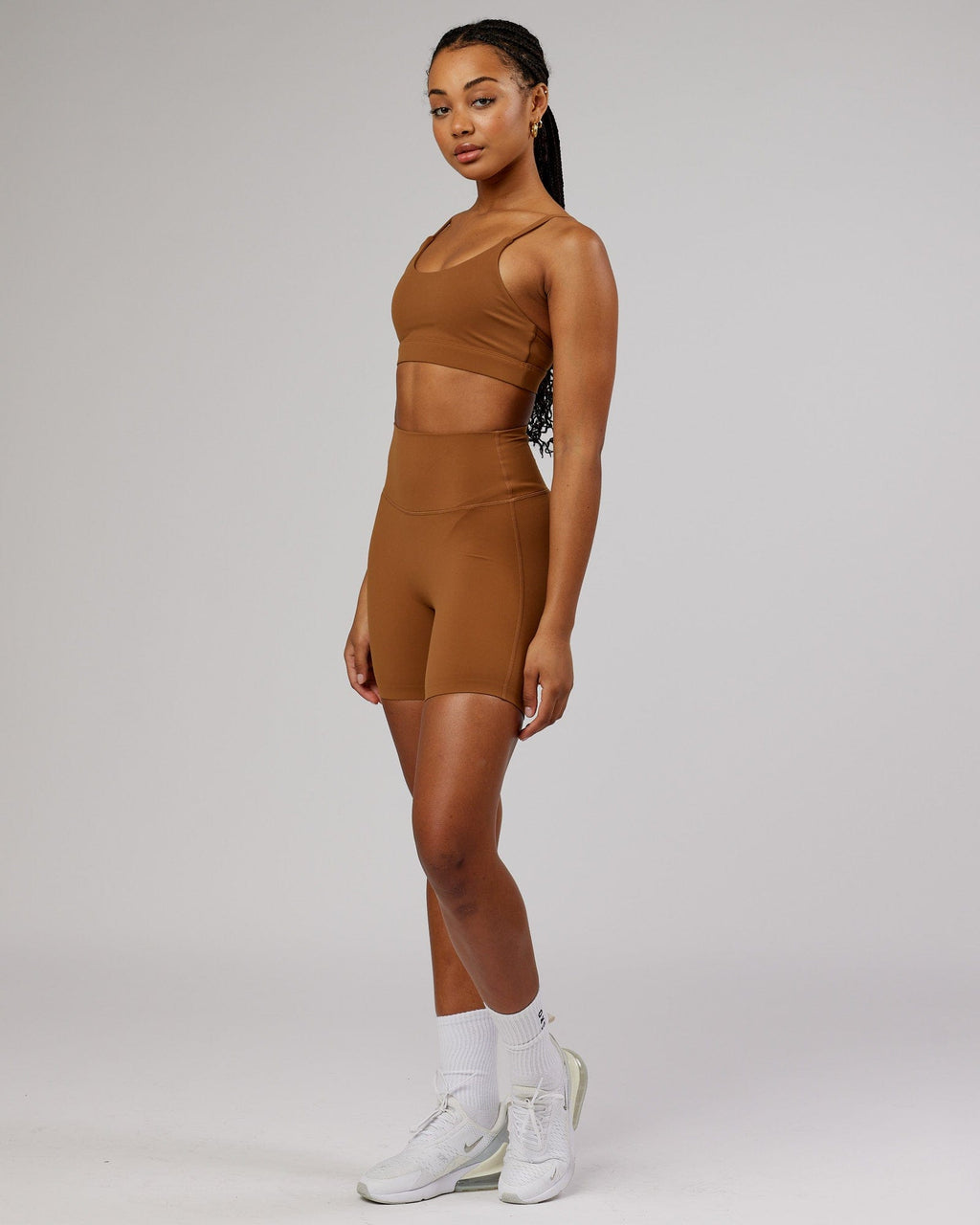 Model wearing Elixir Mid Short Tight - Camel