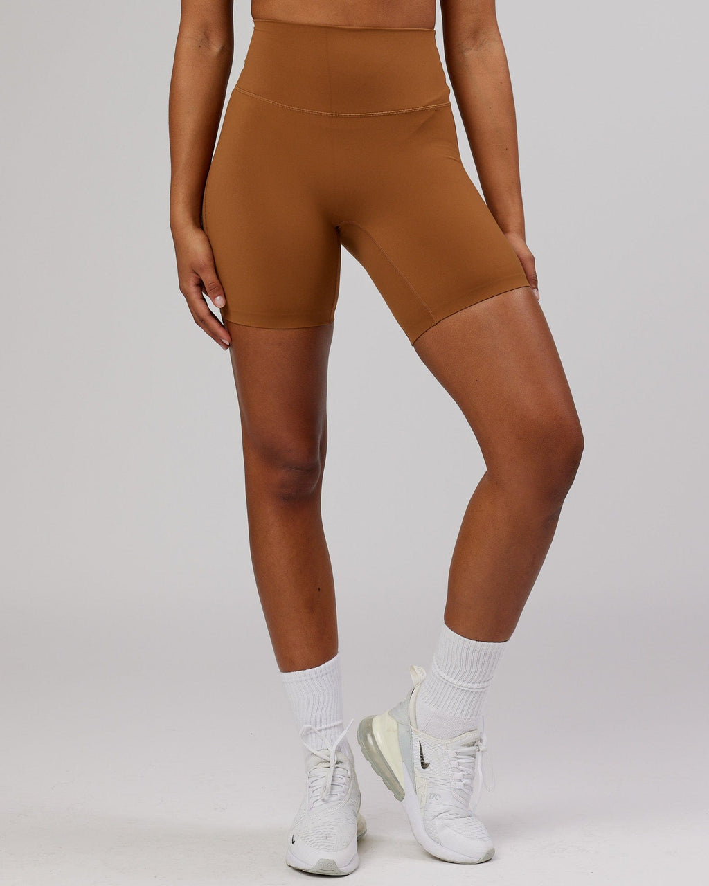 Model wearing Elixir Mid Short Tight - Camel