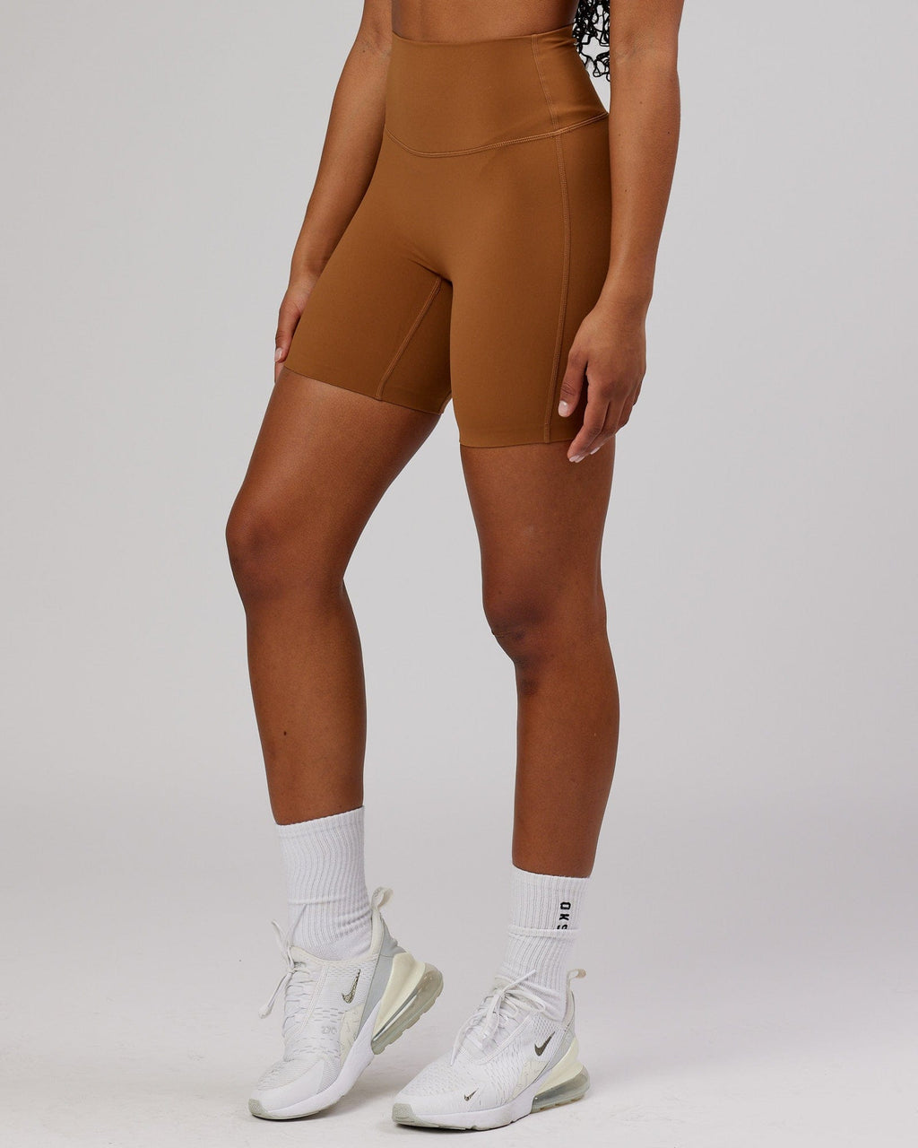 Model wearing Elixir Mid Short Tight - Camel