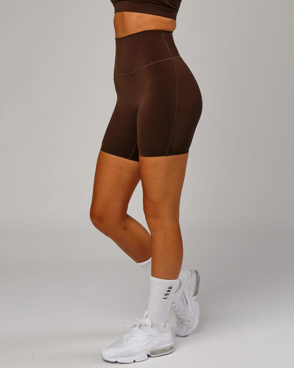 Model wearing Elixir Mid Short Tight - Chocolate No Logo