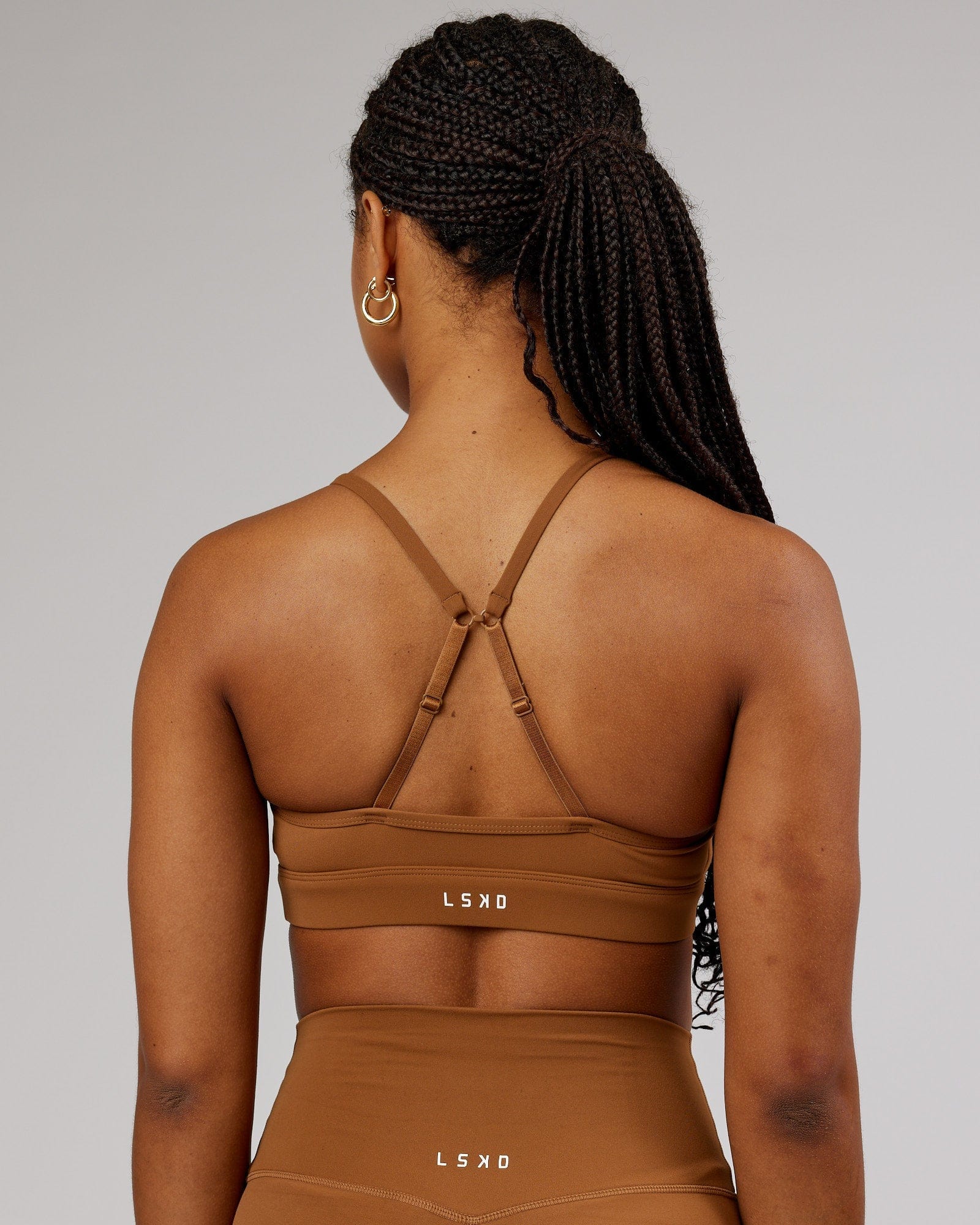 Model wearing Elixir Sports Bra - Camel