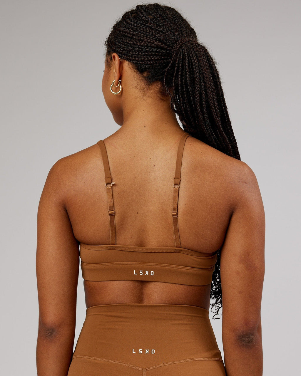 Model wearing Elixir Sports Bra - Camel