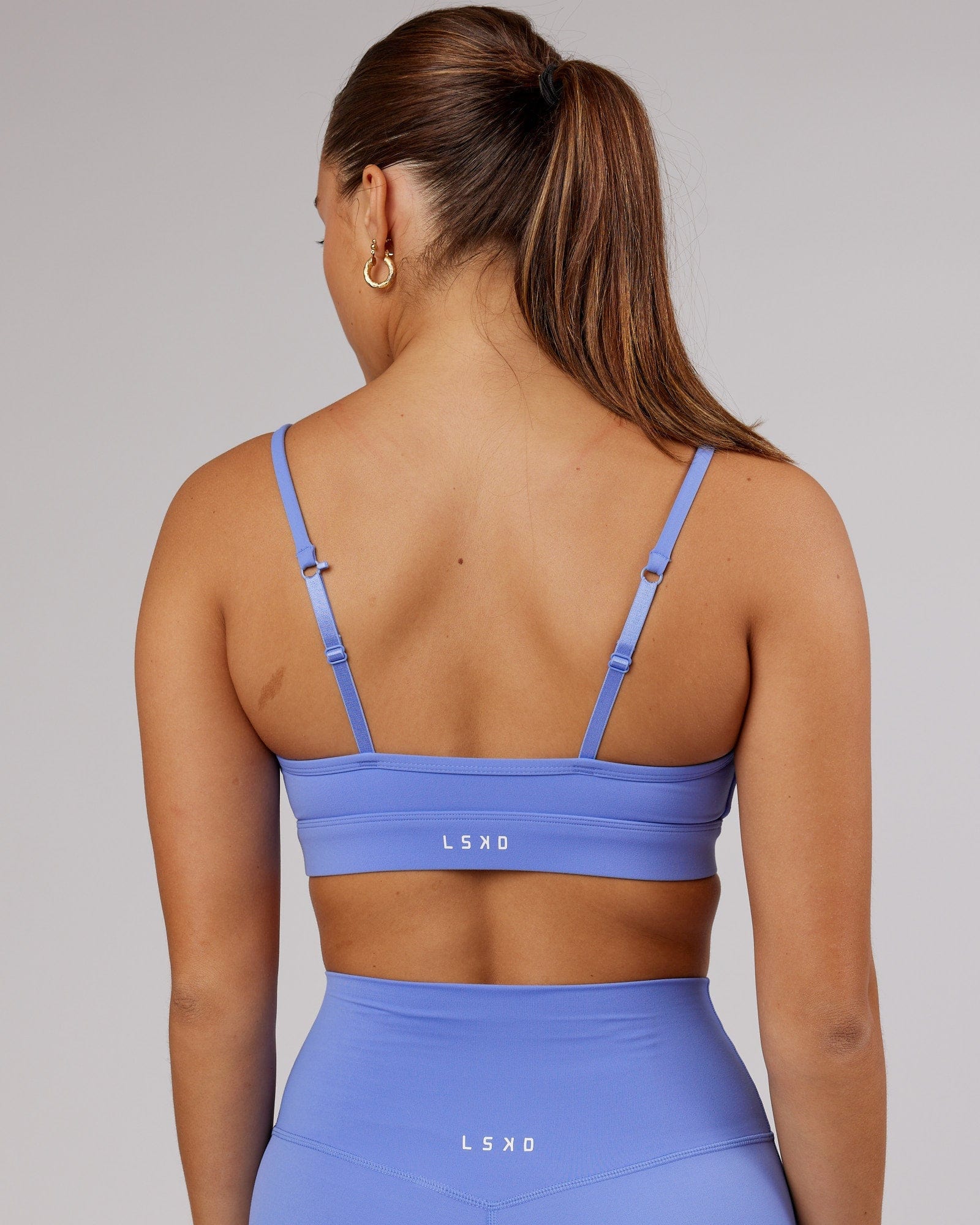 Model wearing Elixir Sports Bra - Indulgent Blue