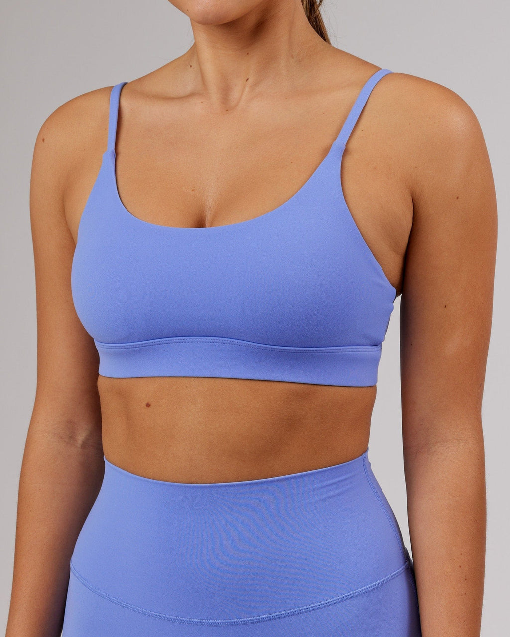 Model wearing Elixir Sports Bra - Indulgent Blue