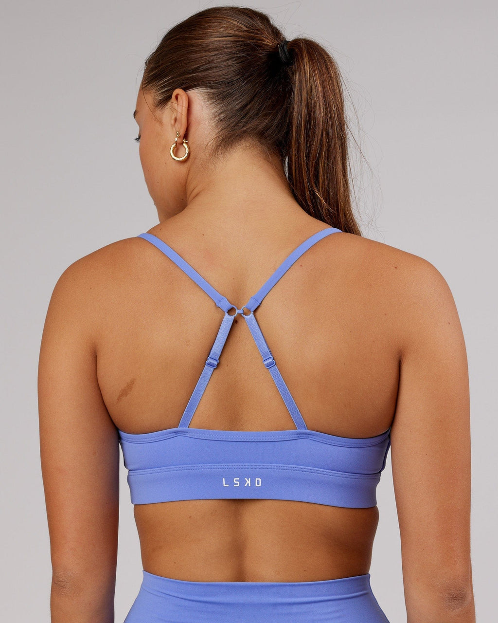 Model wearing Elixir Sports Bra - Indulgent Blue