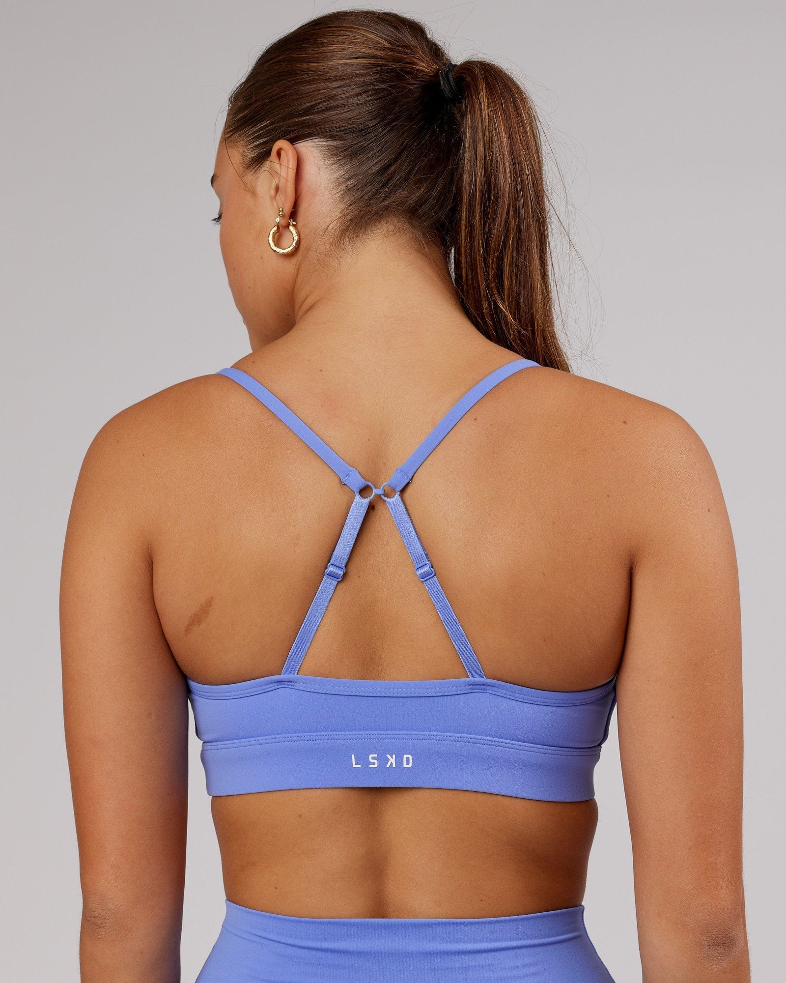 Model wearing Elixir Sports Bra - Indulgent Blue
