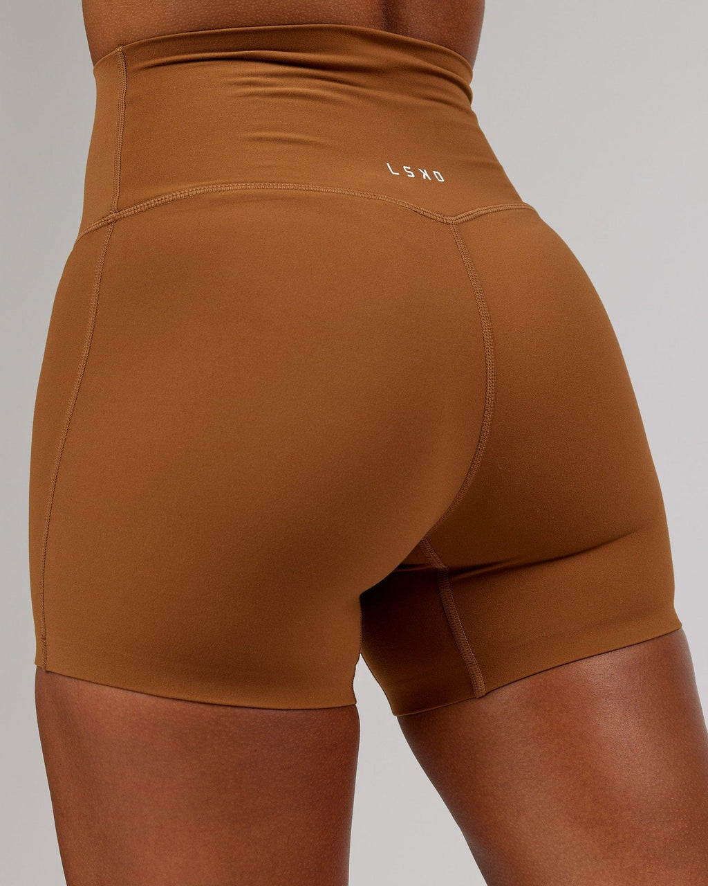 Model wearing Elixir X-Short Tight - Camel