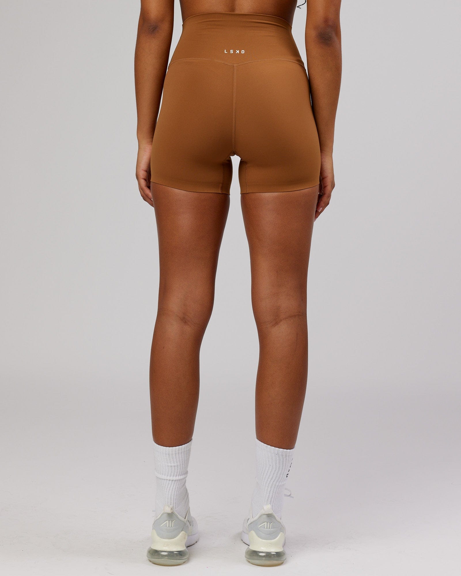 Model wearing Elixir X-Short Tight - Camel