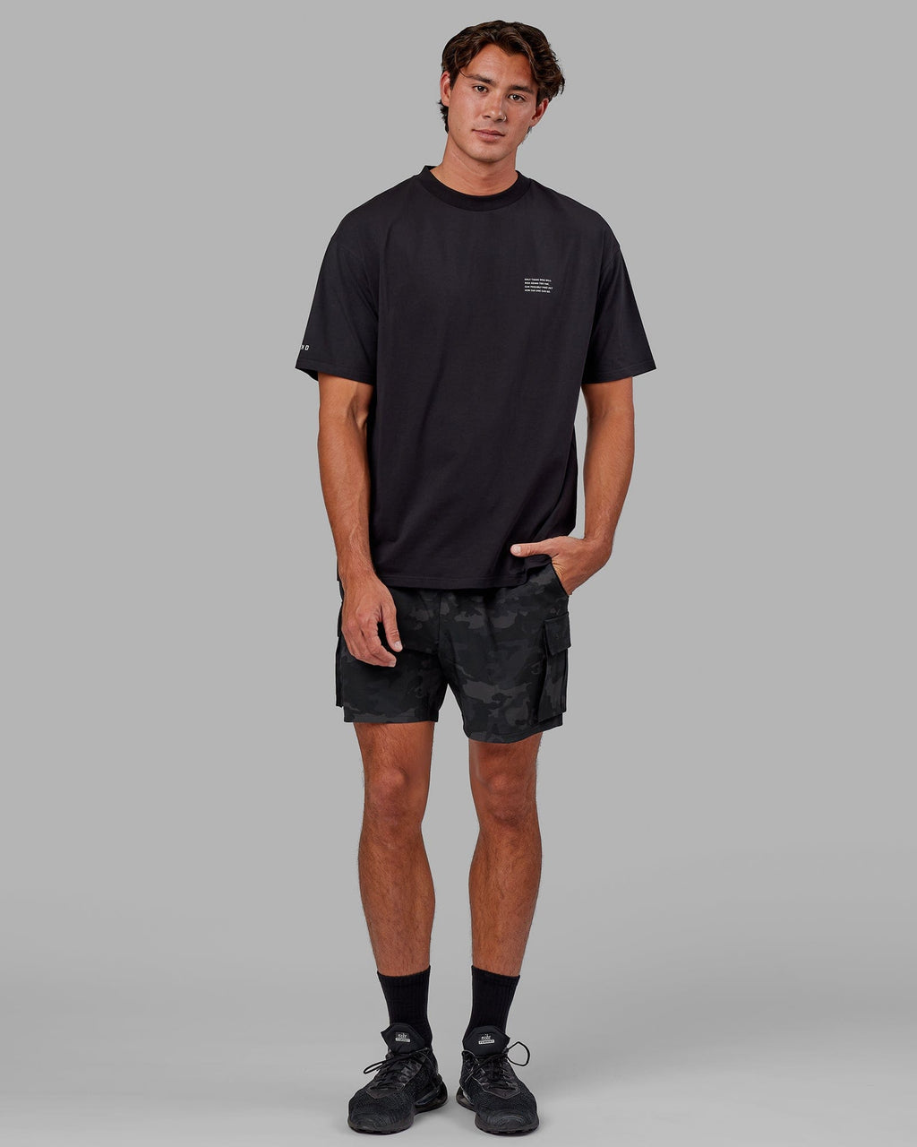 Model wearing Energy Stretch Performance Cargo Short - Black Camo