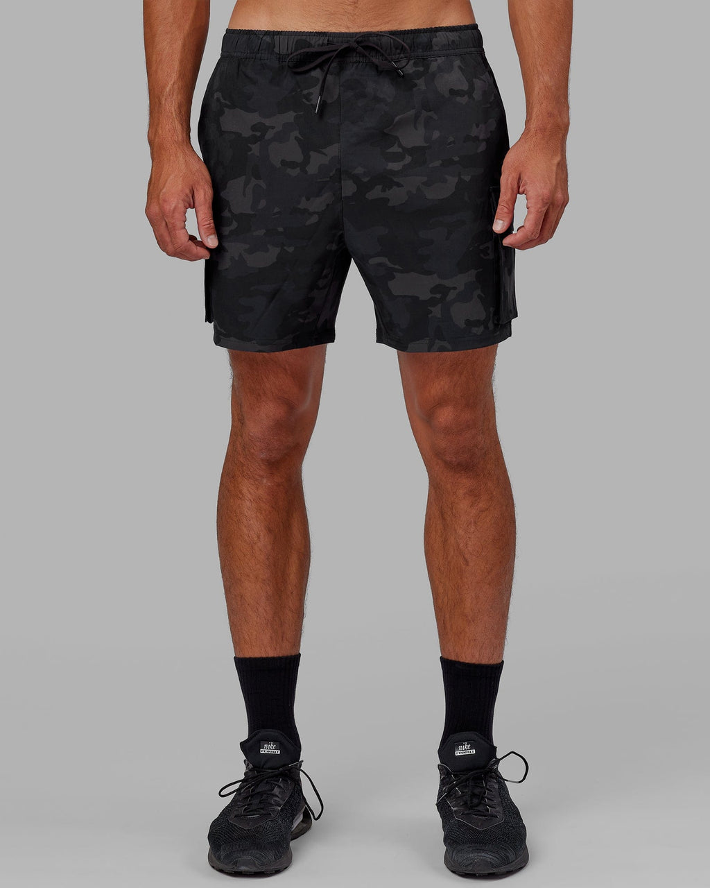 Model wearing Energy Stretch Performance Cargo Short - Black Camo
