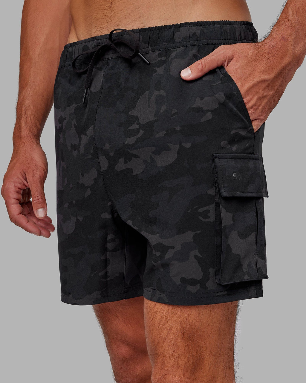 Model wearing Energy Stretch Performance Cargo Short - Black Camo