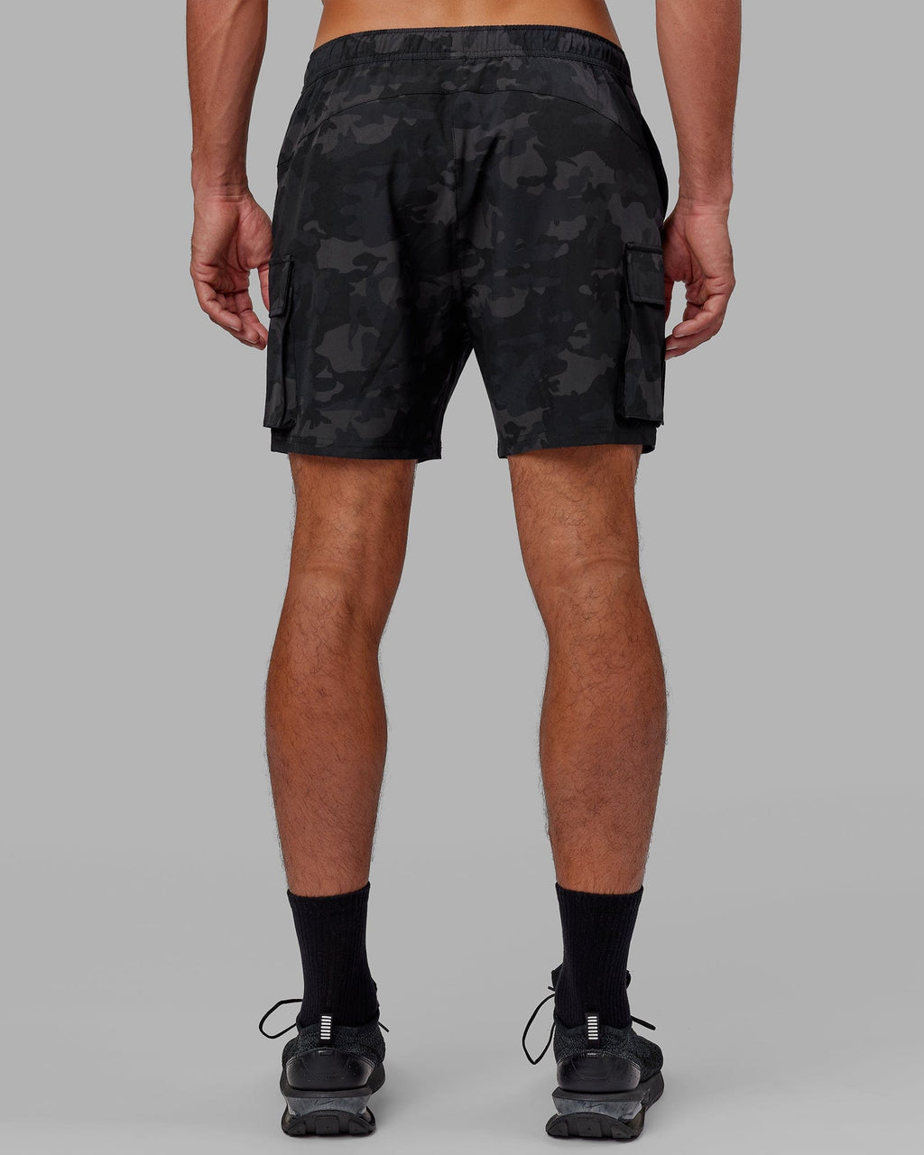 Model wearing Energy Stretch Performance Cargo Short - Black Camo