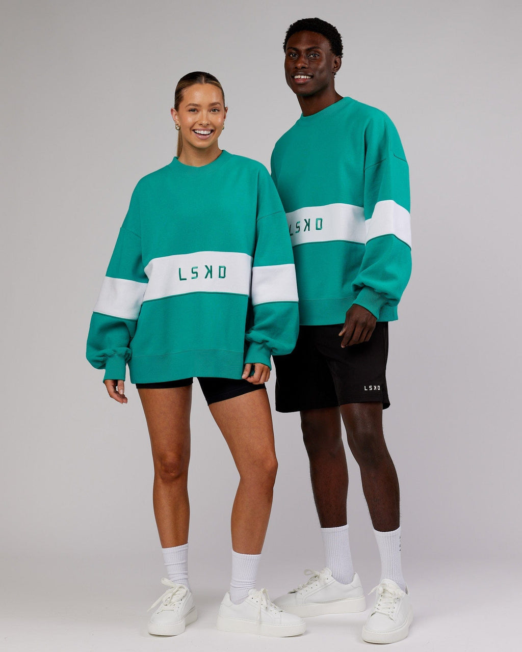 Model wearing Unisex Extra Time Sweater Oversize - Hyper Teal