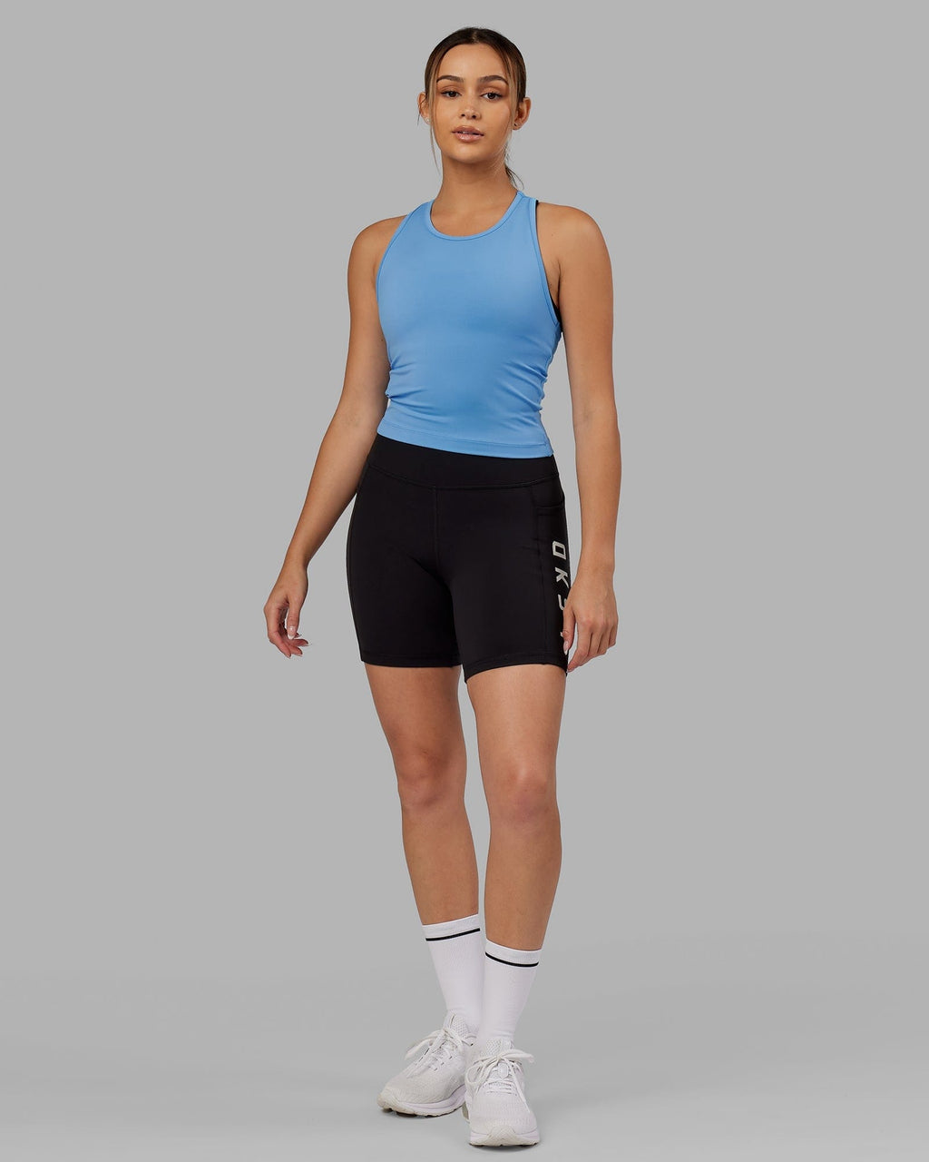 Model wearing Flow Performance Tank - Azure Blue