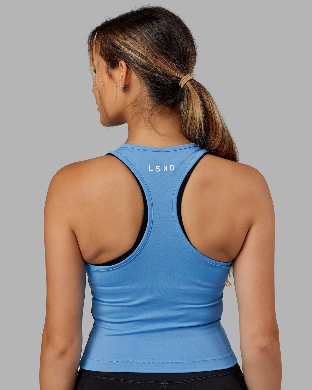 Model wearing Flow Performance Tank - Azure Blue