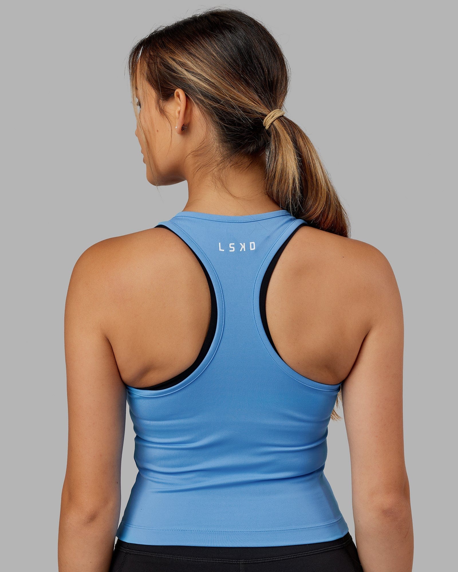 Model wearing Flow Performance Tank - Azure Blue