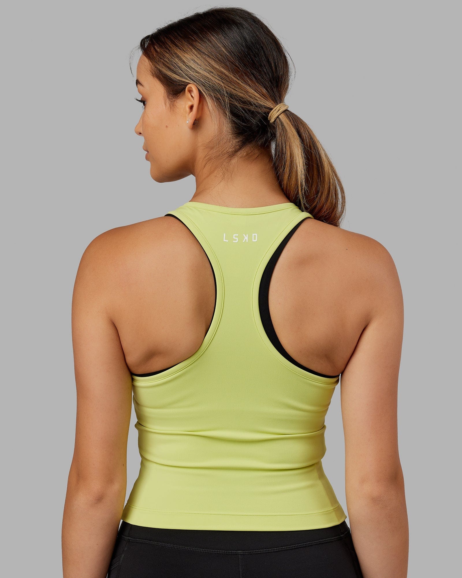 Model wearing Flow Performance Tank - Pale Citrus