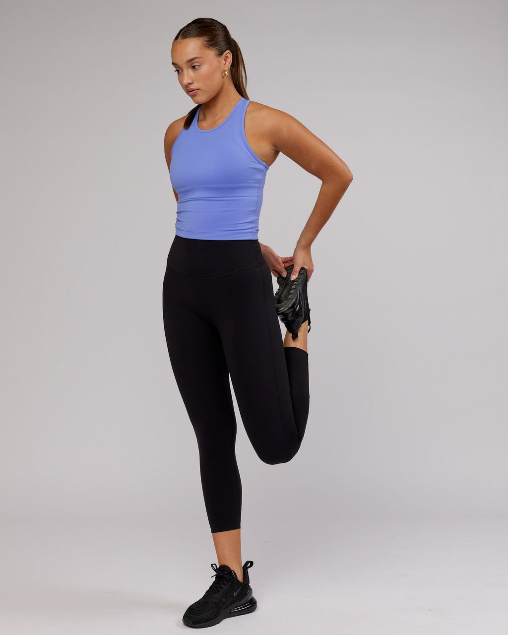 Model wearing Flow Performance Tank - Cornflower Blue