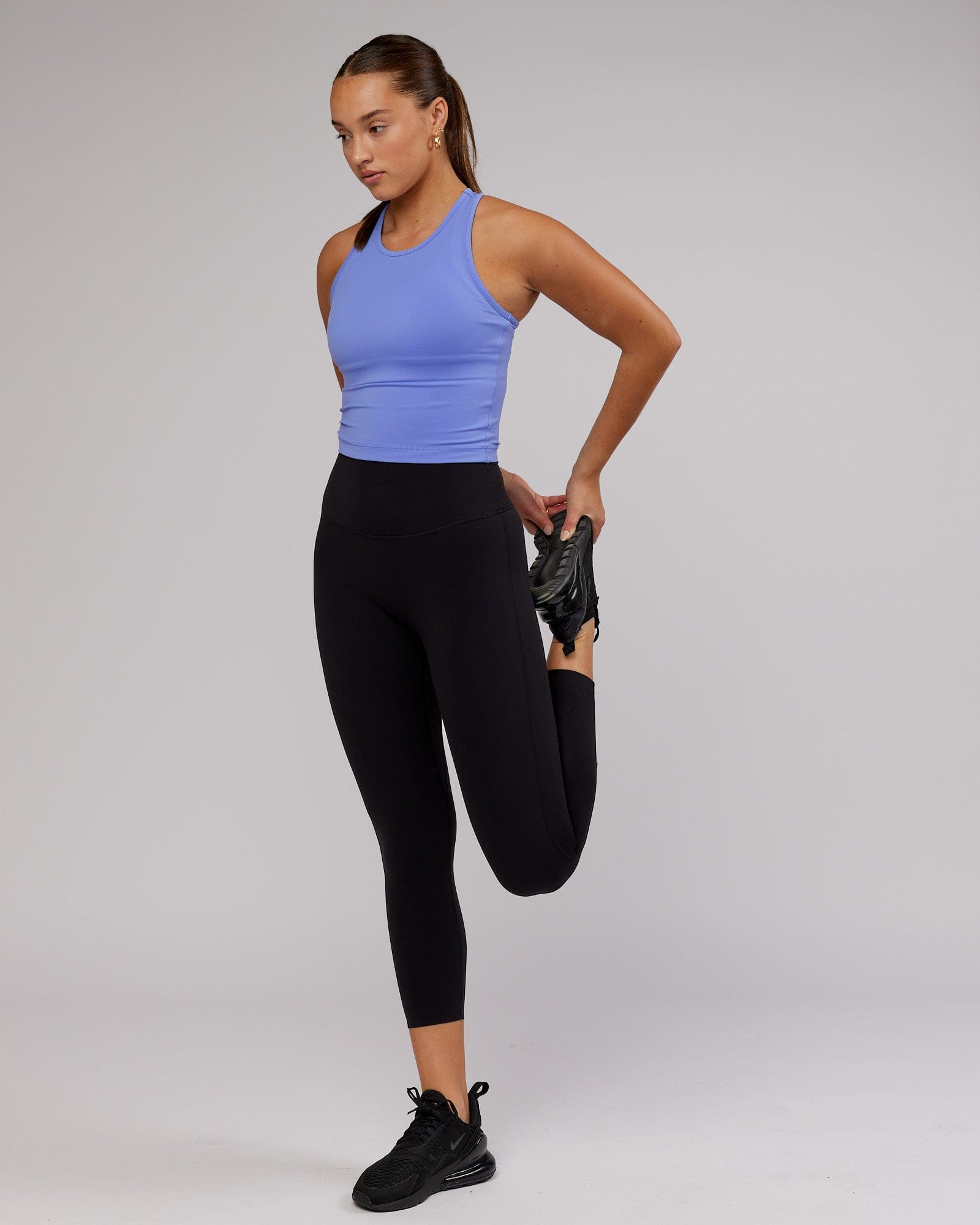 Model wearing Flow Performance Tank - Cornflower Blue